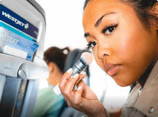 image of a girl on plane using Subtl Beauty's brush from their travel makeup kit